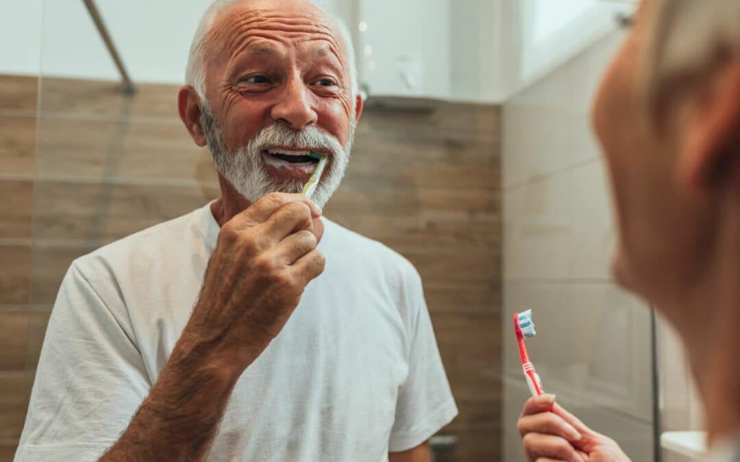 elderly man brushing his teeth