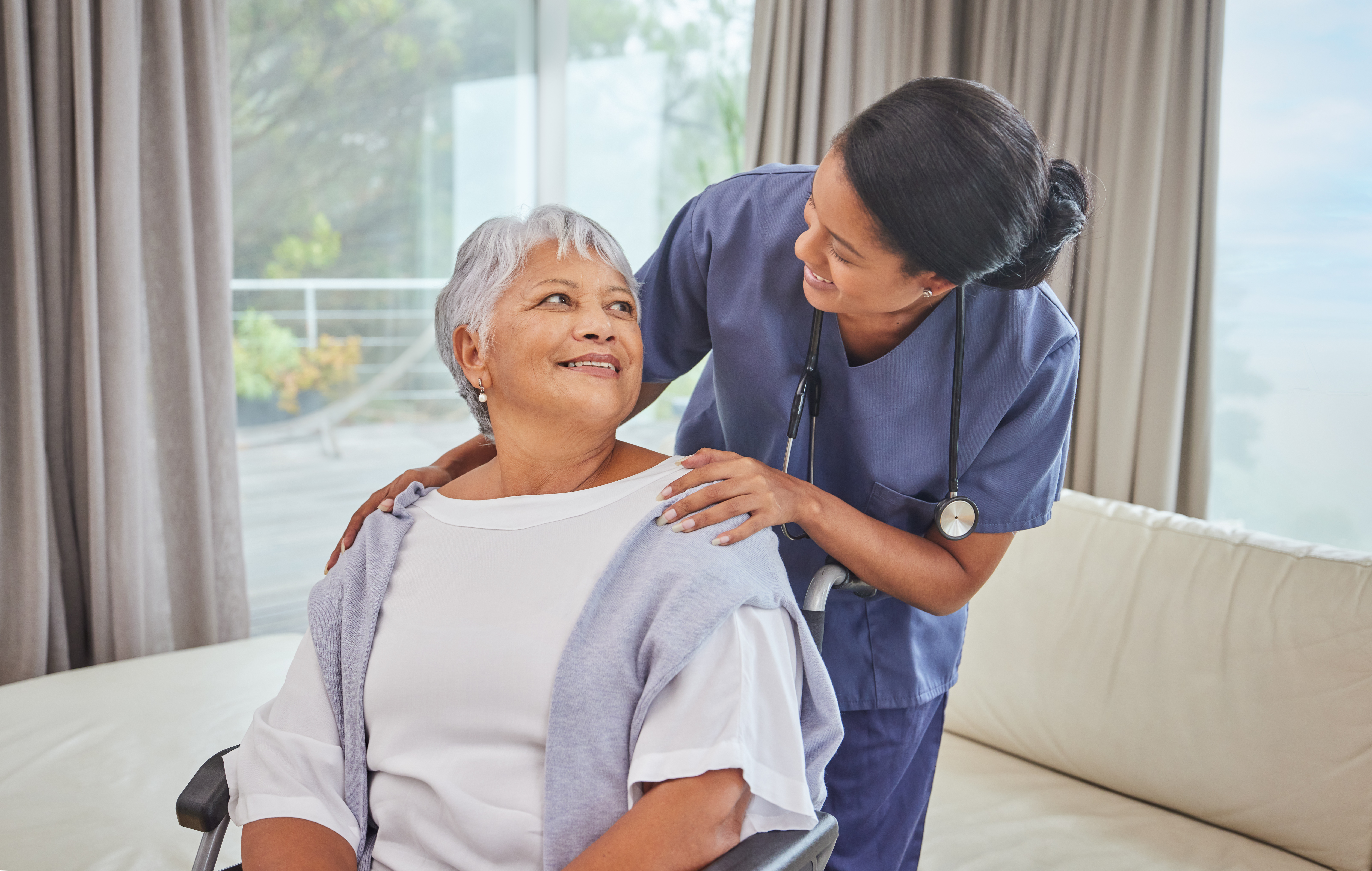 A senior being assisted by a nurse in an assisted living facility.